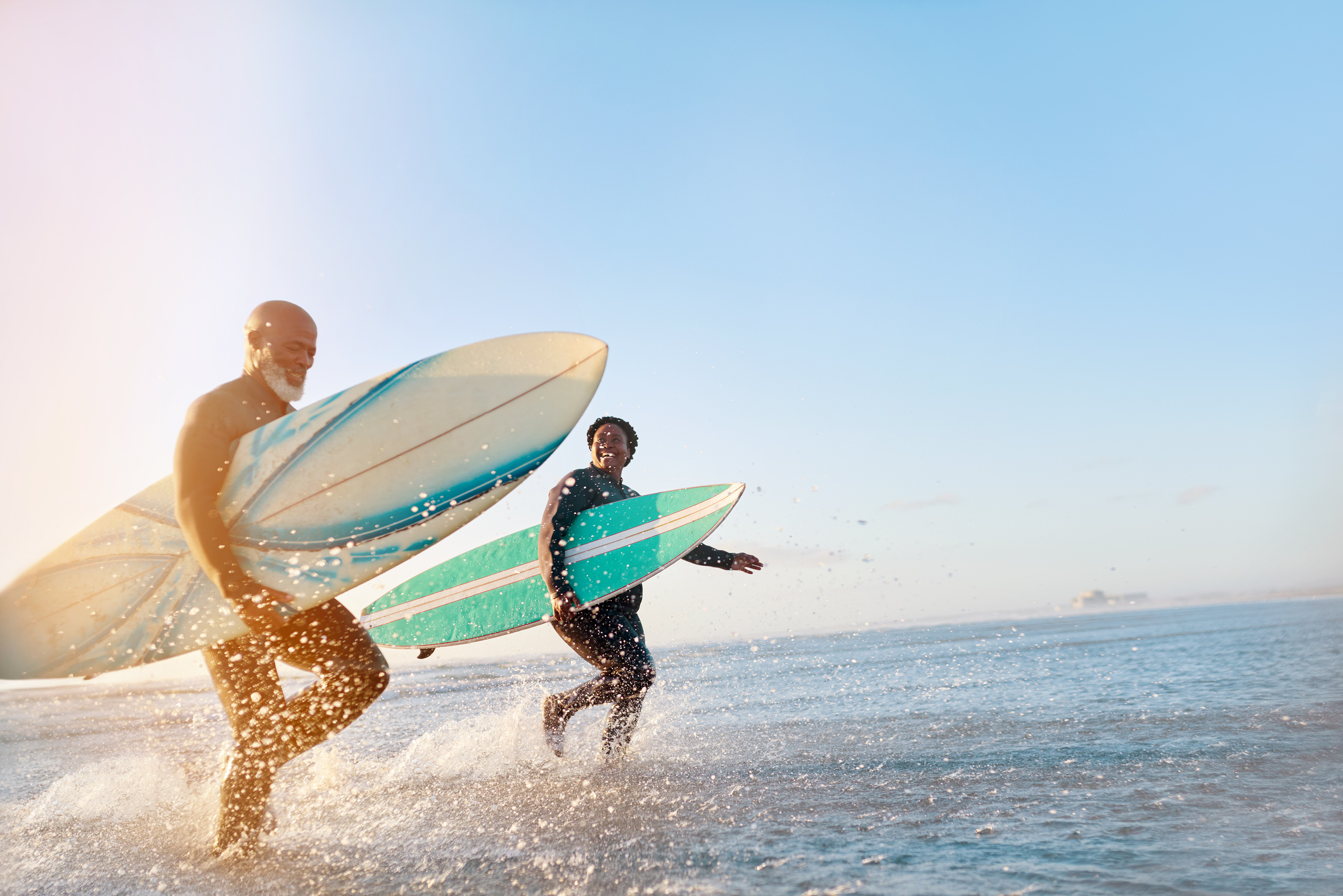 Shot of a mature couple surfing at the beach